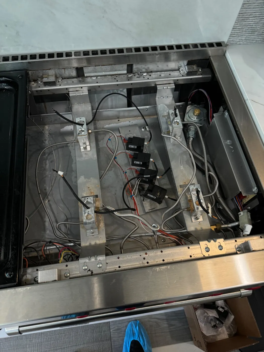 Professional range with cooktop removed for internal repair
