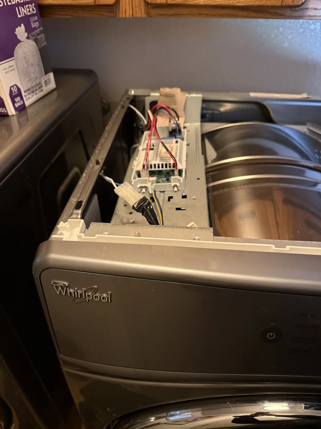 Whirlpool dryer with control panel removed for repair